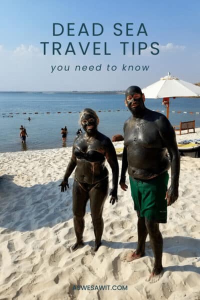 The author and her husband covered in Dead Sea mud, smiling at the camera. The Text overlay says "Dead Sea travel tips you need to know"