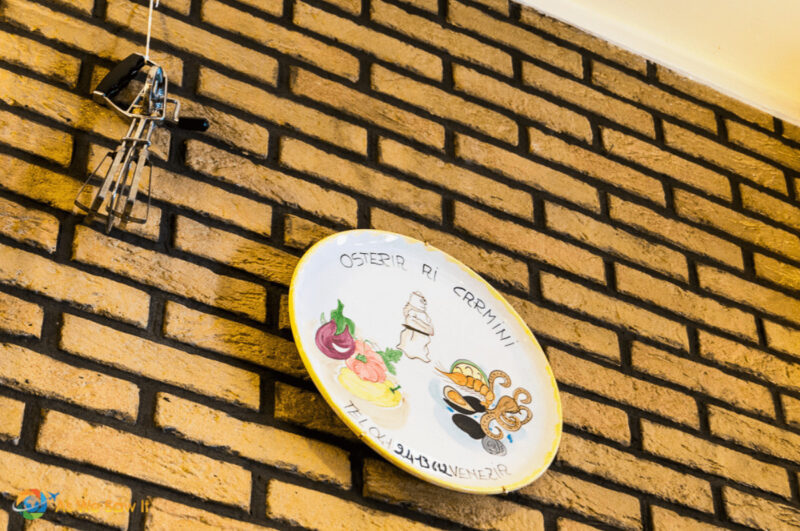 A plate on the wall at a local osteria in Venice
