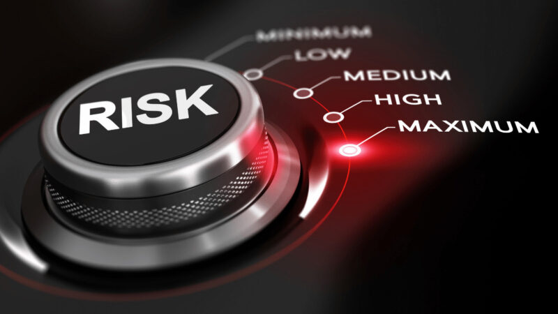 A dial illustrating that risk is cranked up to Maximum