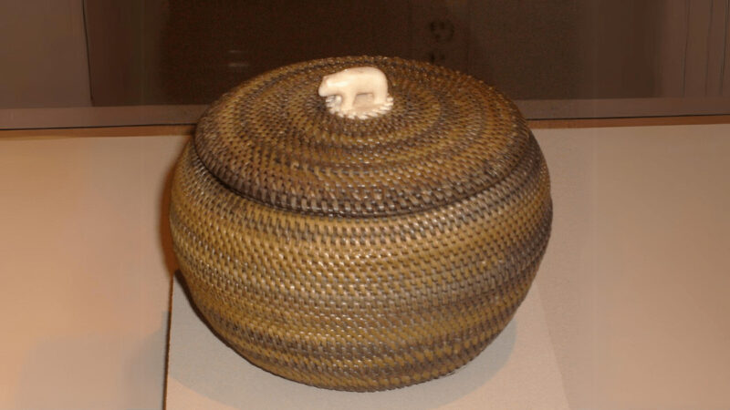 Inupiat baleen basket with an ivory handle (finial), made by Kinguktuk (Kiŋaqtaq 1871–1941) of Barrow, Alaska. Displayed at the Museum of Man, San Diego, California.