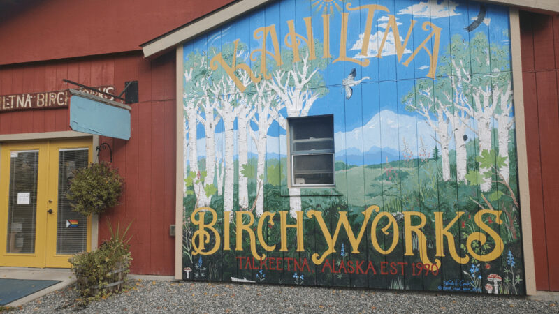 A wall mural of birch trees, on the outside of Kahiltna Birchworks.