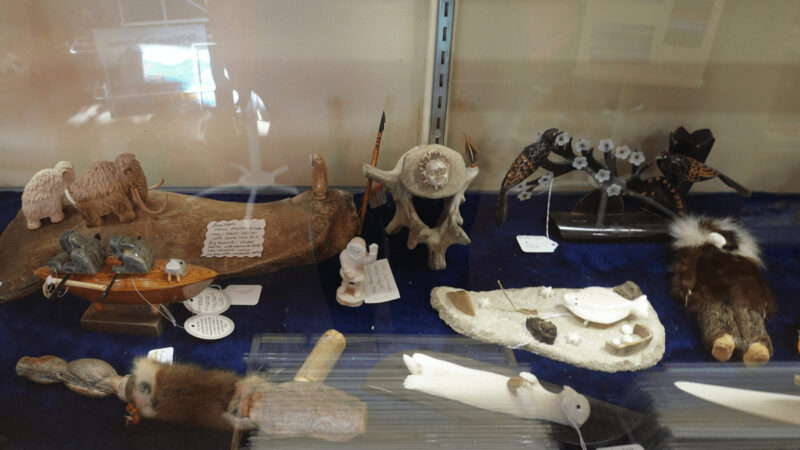 A display of soapstone and ivory carvings by Native Alaskan craftsmen.