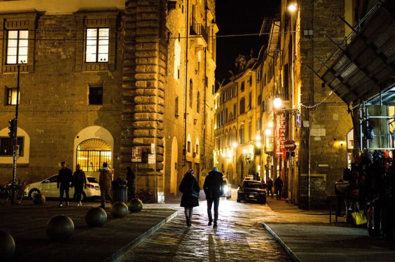 people on a street, enjoying nightlife in Florence at night