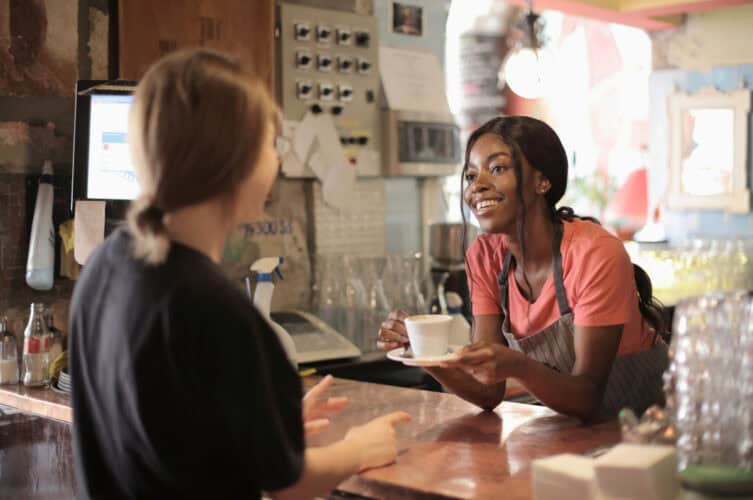 A barista in a cafe making small talk