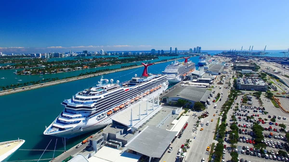 Cruise ships docked at PortMiami with the Miami skyline in the background