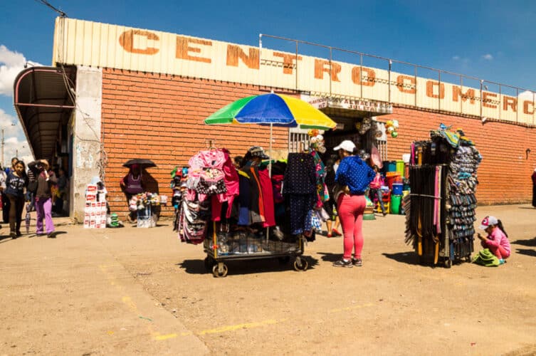 Outdoor Andean market showing vendors and shoppers as part of everyday life in Peru