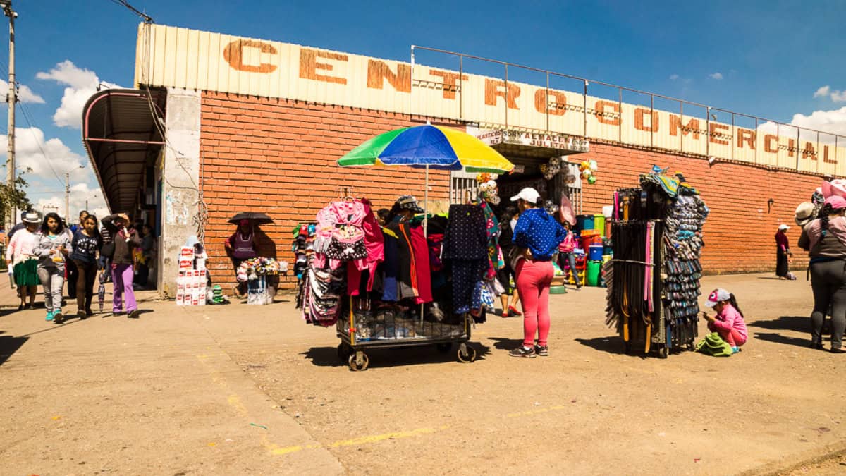 Outdoor Andean market showing vendors and shoppers as part of everyday life in Peru
