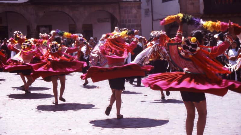 Traditional festival dancers performing in Cusco, Peru, during a community celebration rooted in Andean beliefs