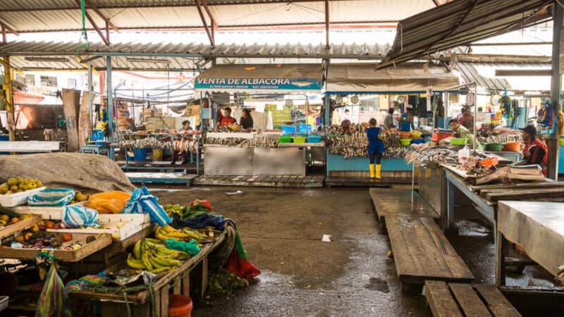 Busy indoor market in Peru showing everyday commerce shaped by long-standing Andean traditions