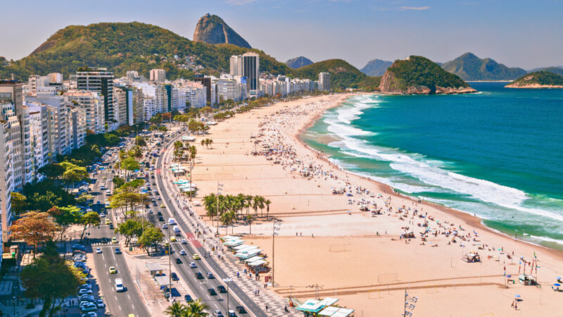 Copacabana Beach and skyline along the Atlantic coast in Rio de Janeiro. Copacabana is one of the best places to stay in Rio.