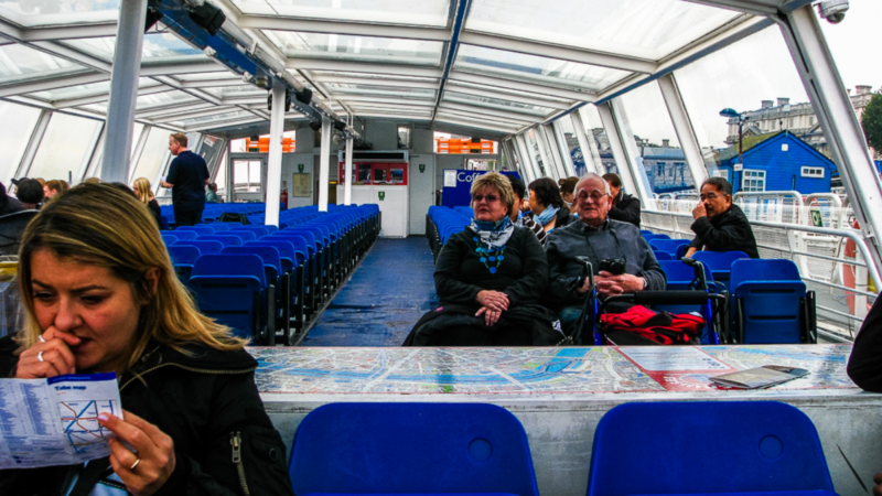 Passengers waiting on board at the pier before a cruise on the Thames River begins