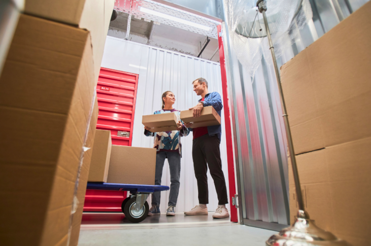 Couple unloading boxes inside a self-storage unit