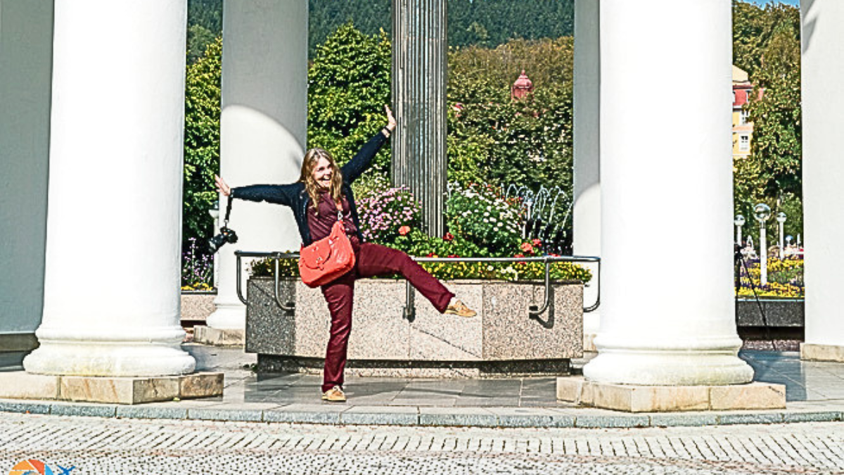 Linda sightseeing in Czechia with a red crossbody bag