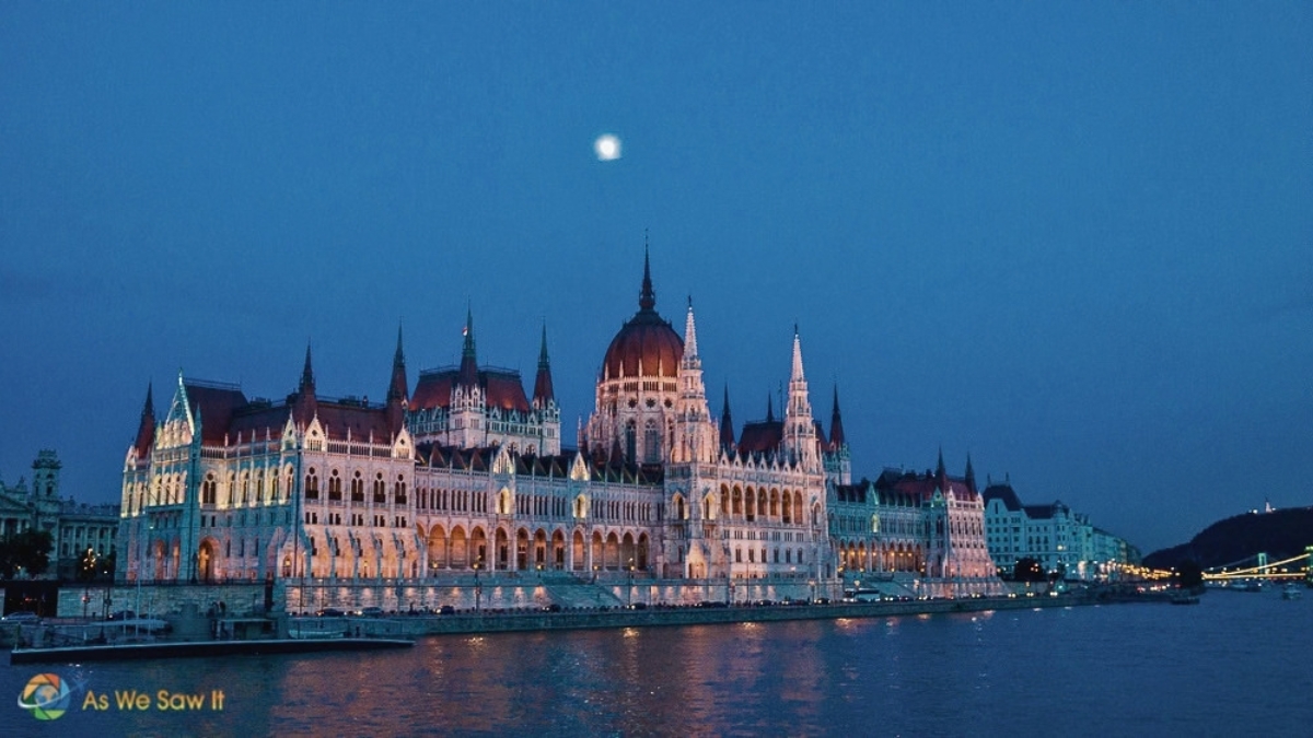 Hungarian Parliament Building lit up and reflected on the Danube, taken during a river cruise in Budapest,