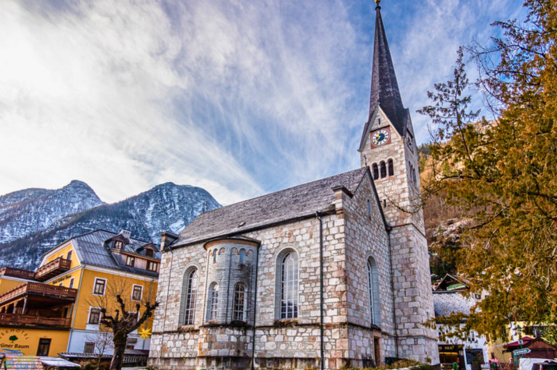 Evangelical Church in Hallstatt with snow-covered mountains in winter