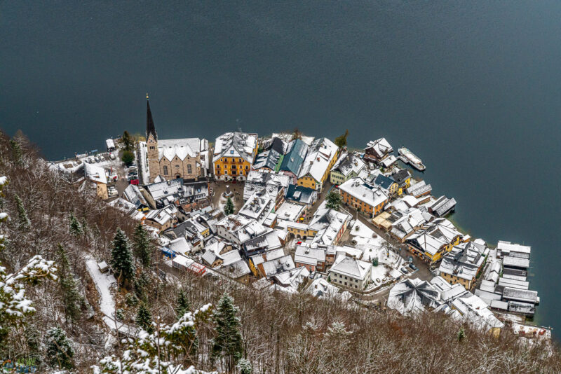 Snow-dusted Hallstatt village seen from above beside the lake