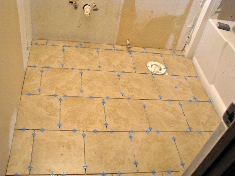 tiles on the floor of the bathroom waiting for the grout