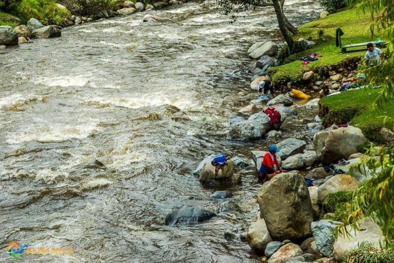 Local women washing clothes in a river in Cuenca Ecuador