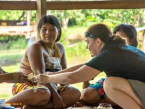 Linda buys a handmade basket from an Embera Indian woman in the Darien, Panama