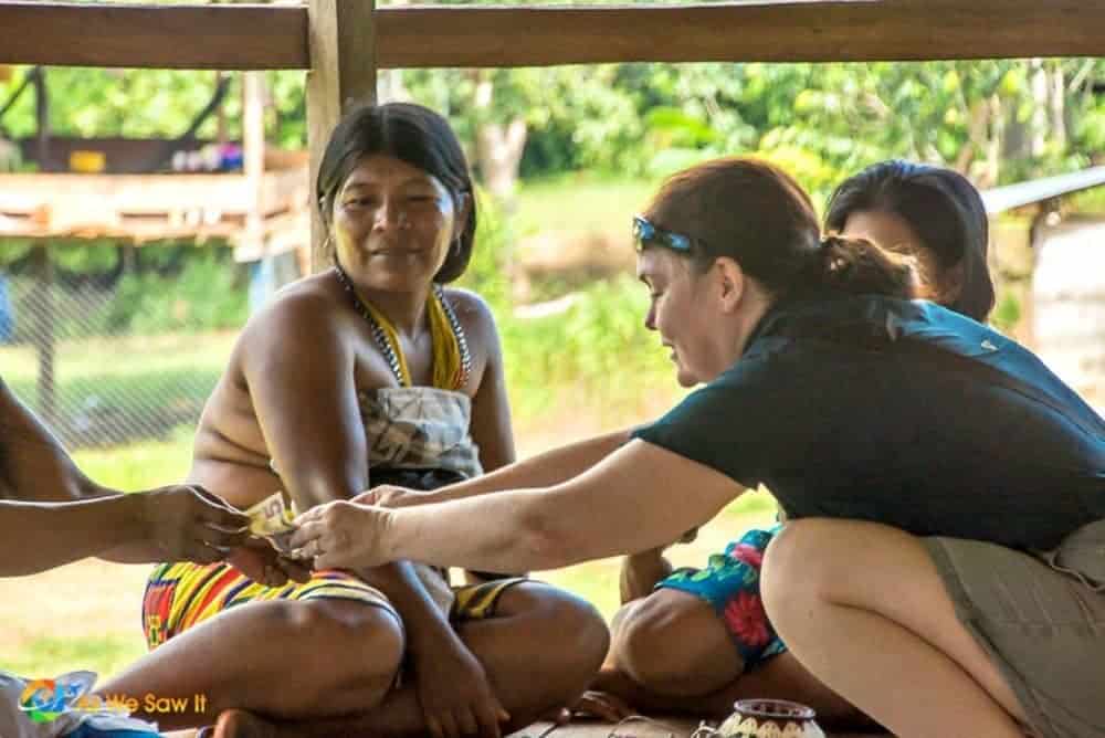 Linda buys a handmade basket from an Embera Indian woman in the Darien, Panama