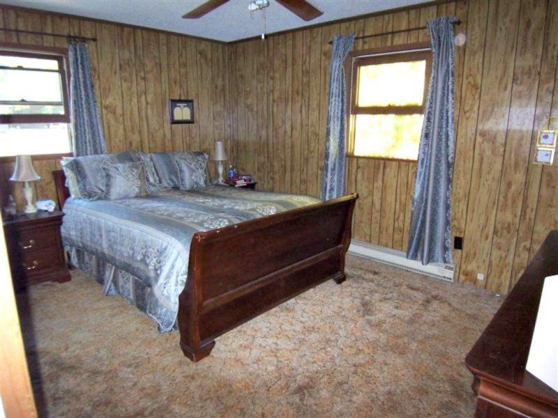 Master bedroom with fake wood paneling, circa 1975