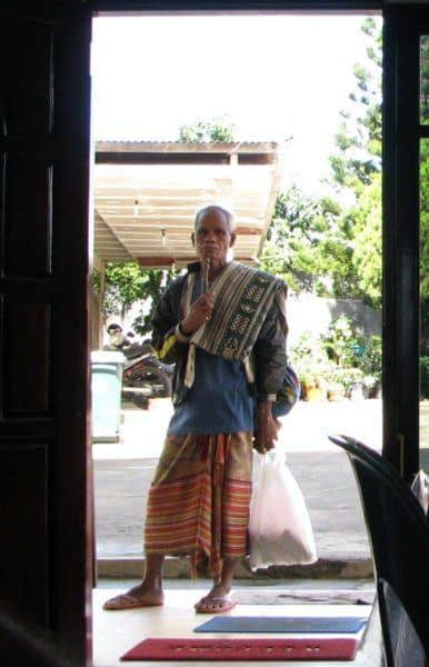 Honey vendor stands in door of hotel